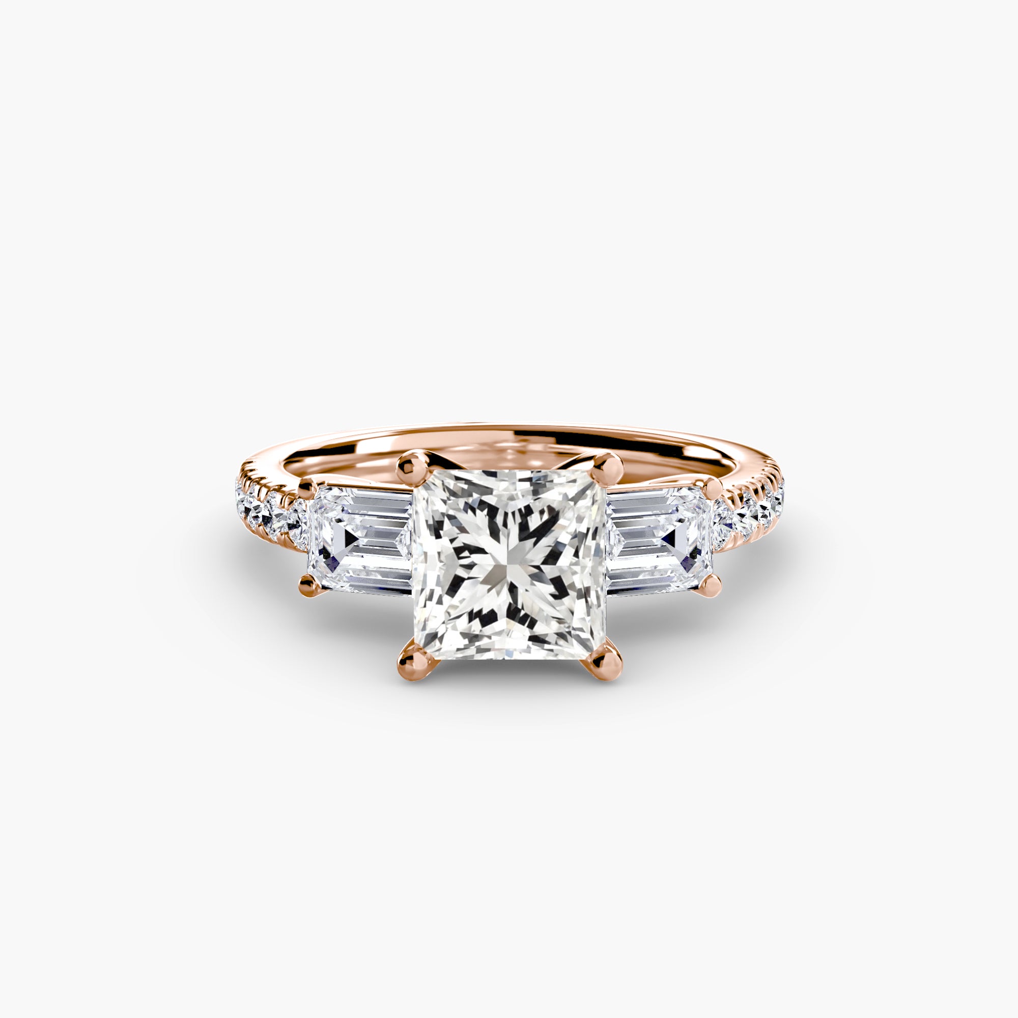 The MICHAEL ISAAC Three-Stone Ring with Pavé Band 4 is an elegant rose gold ring with a large princess-cut diamond center, trapezoid side stones, and a pavé band of round diamonds, shown on a white background.