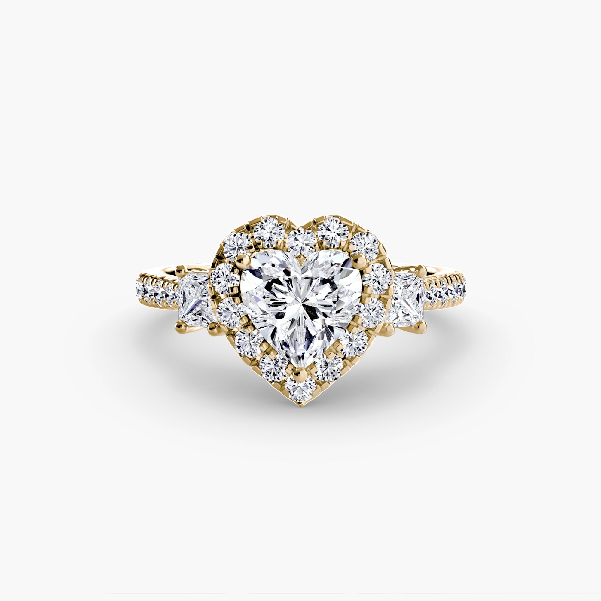 The MICHAEL ISAAC Three-Stone Ring with Halo 2 features a gold band with a large heart-shaped diamond center, radiant halo of smaller diamonds, and diamond accents on the band for a modern touch.