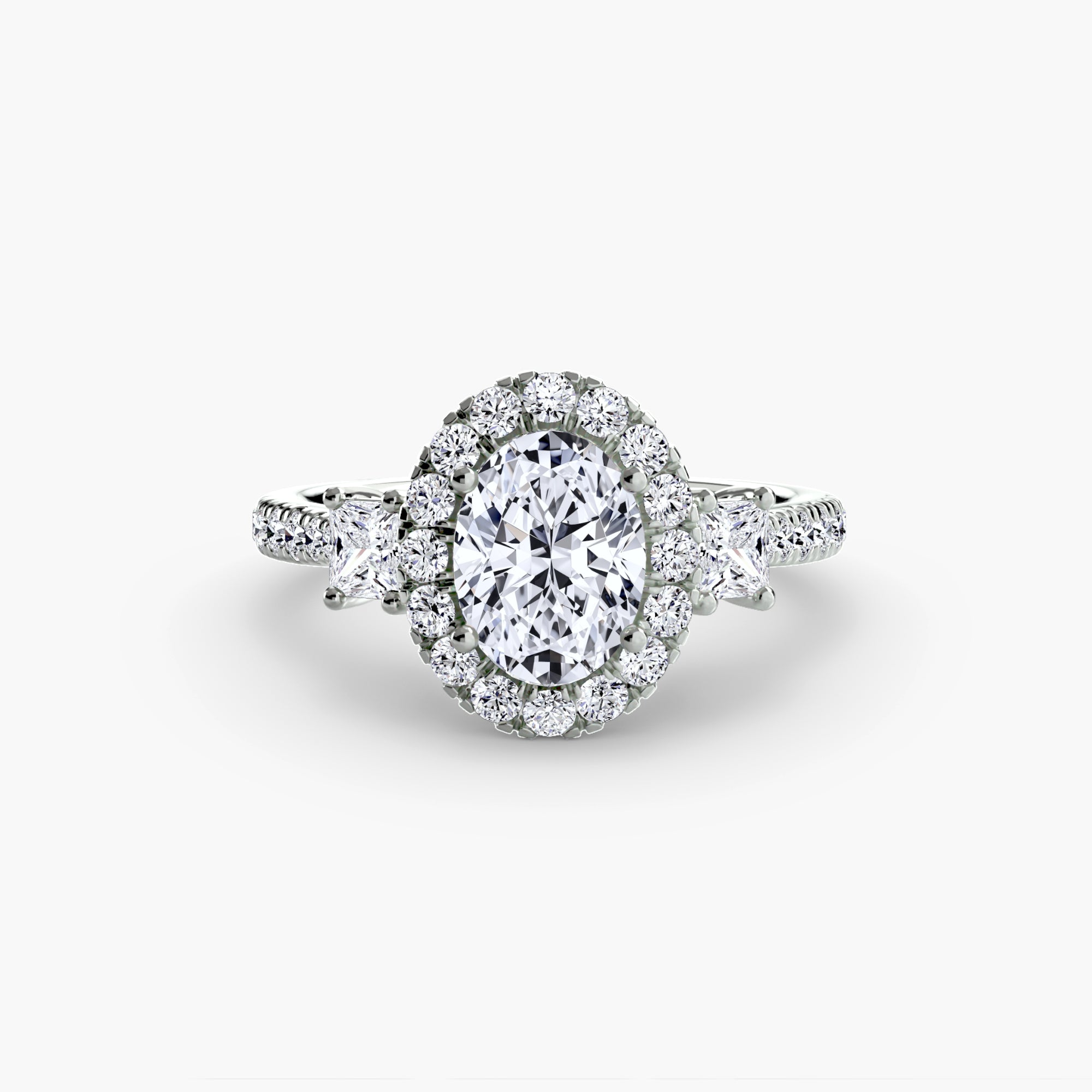 The MICHAEL ISAAC Three-Stone Ring with Halo 2 showcases an oval center diamond with a radiant halo, flanked by two marquise-cut diamonds and a diamond-studded band, displayed on a plain white background.