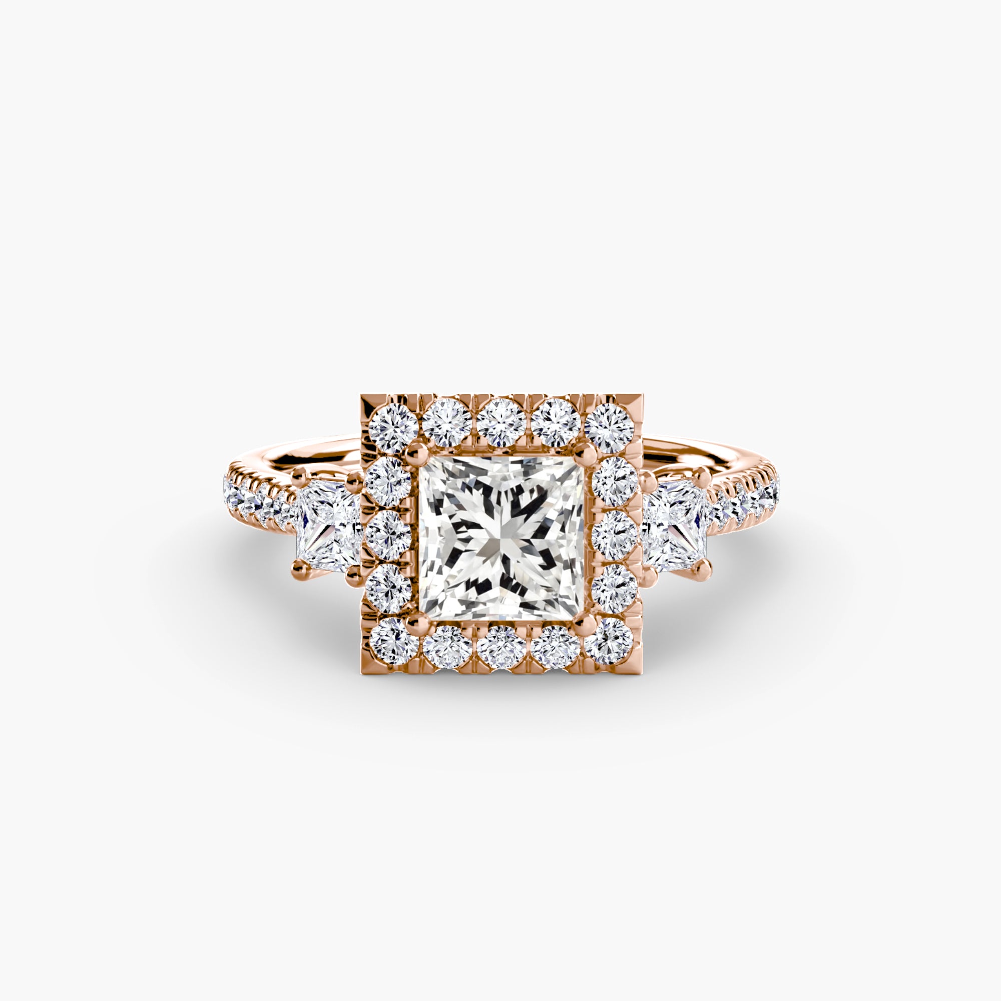 The MICHAEL ISAAC Three-Stone Ring with Halo 2 showcases a rose gold band with a large square-cut center, radiant halo of round diamonds, and extra diamonds on the band, set against a plain white background.