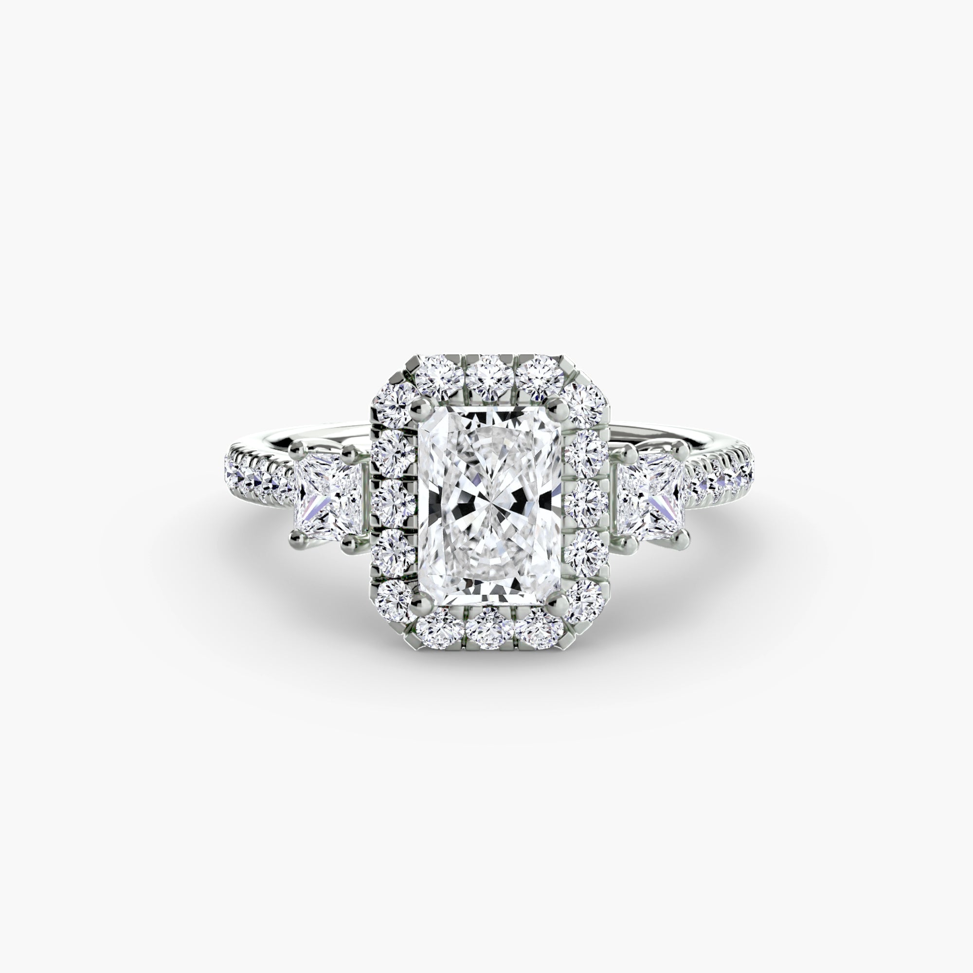 The MICHAEL ISAAC Three-Stone Ring with Halo 2 features a silver band, a central rectangular diamond, radiant halo, two triangular side stones, and additional diamonds along the band.