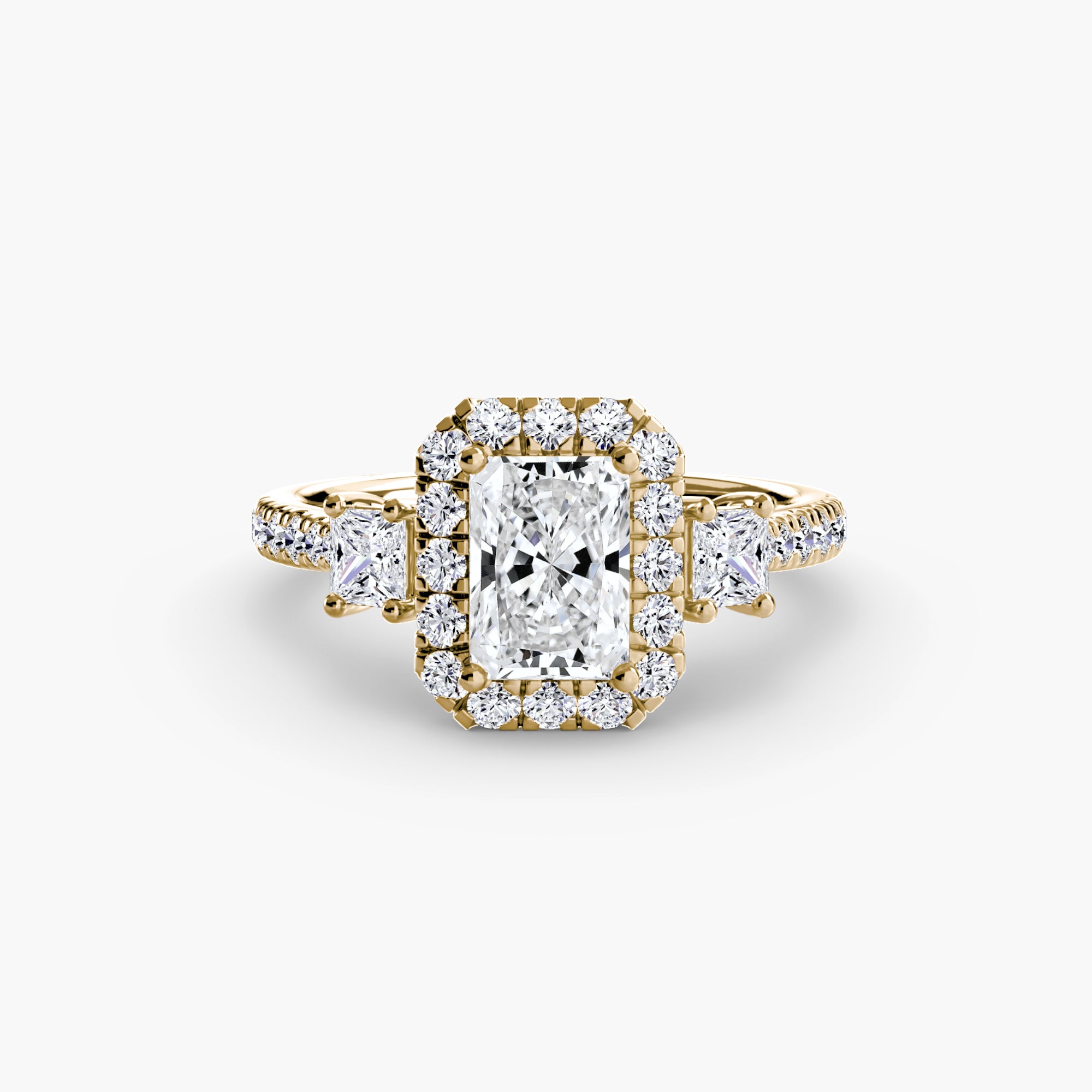 The MICHAEL ISAAC Three-Stone Ring with Halo 2 features a rectangular center diamond, a radiant halo of smaller diamonds, and additional diamonds set along the band for a modern touch.