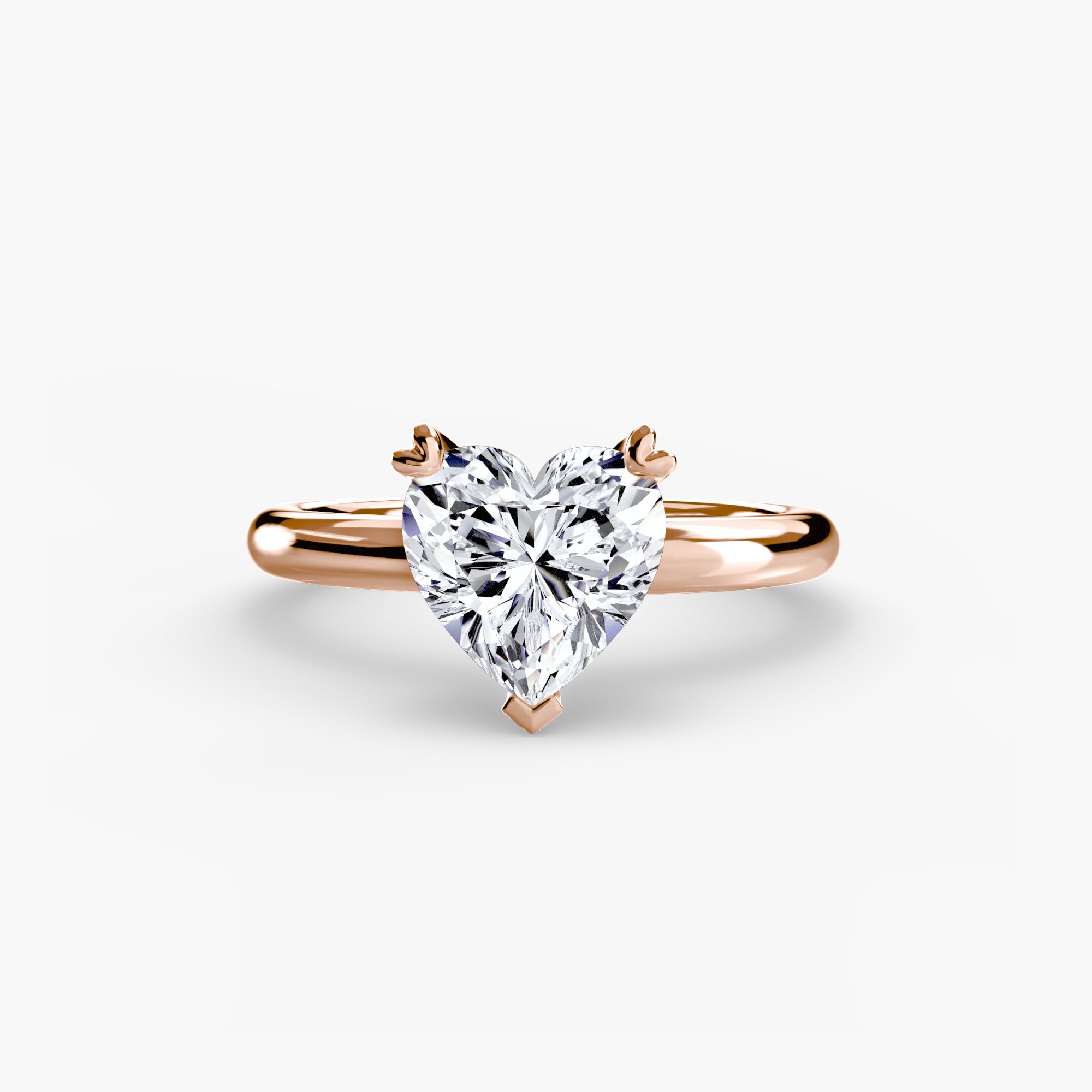 The MICHAEL ISAAC Solitaire ring 2 is a rose gold ring with a heart-shaped clear diamond in a classic solitaire setting and an elegant, simple band, displayed against a white background.