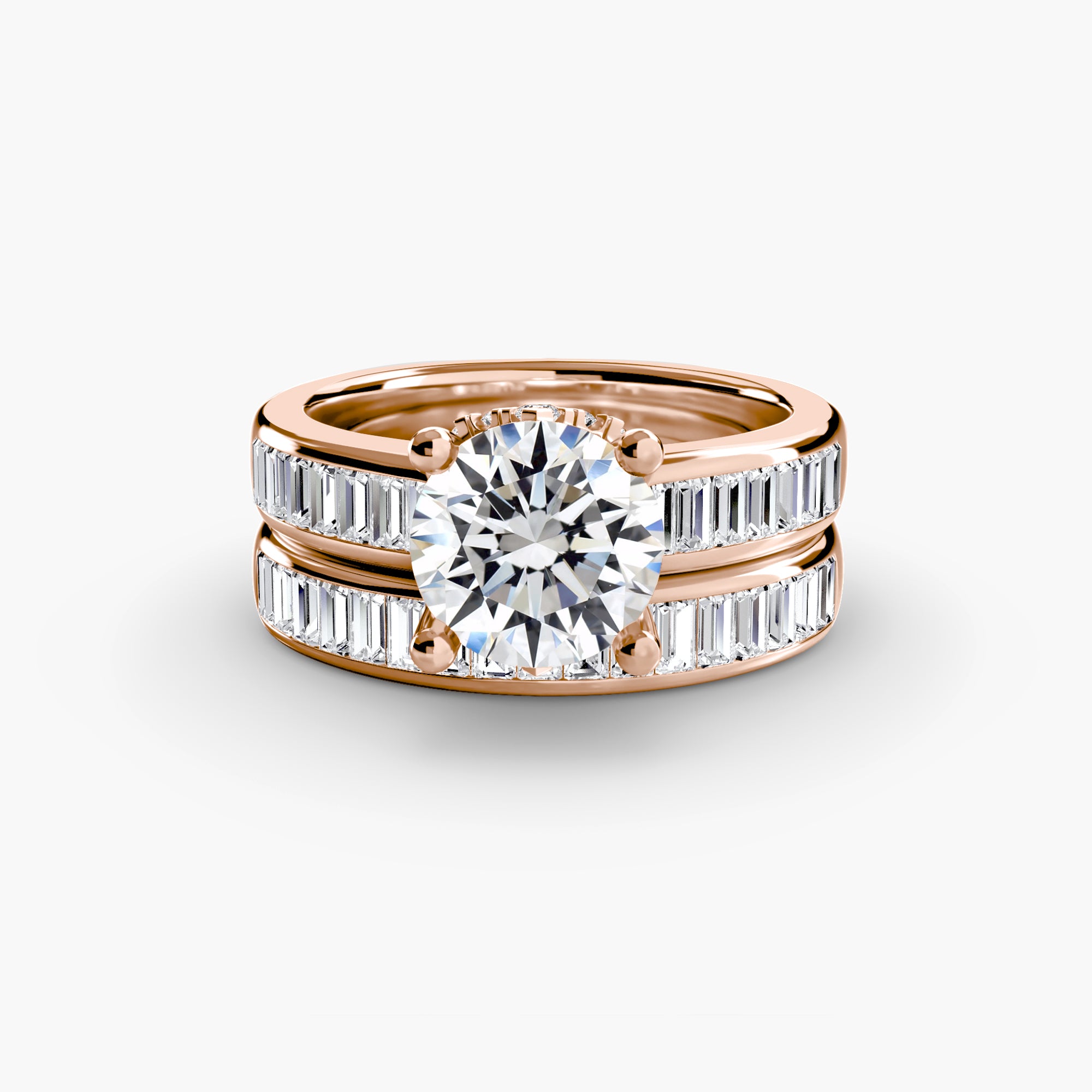 The MICHAEL ISAAC Baguette Channel Solitaire features a classic rose gold band with a large round center diamond and two rows of baguette-cut diamonds, elegantly displayed on a plain white background.