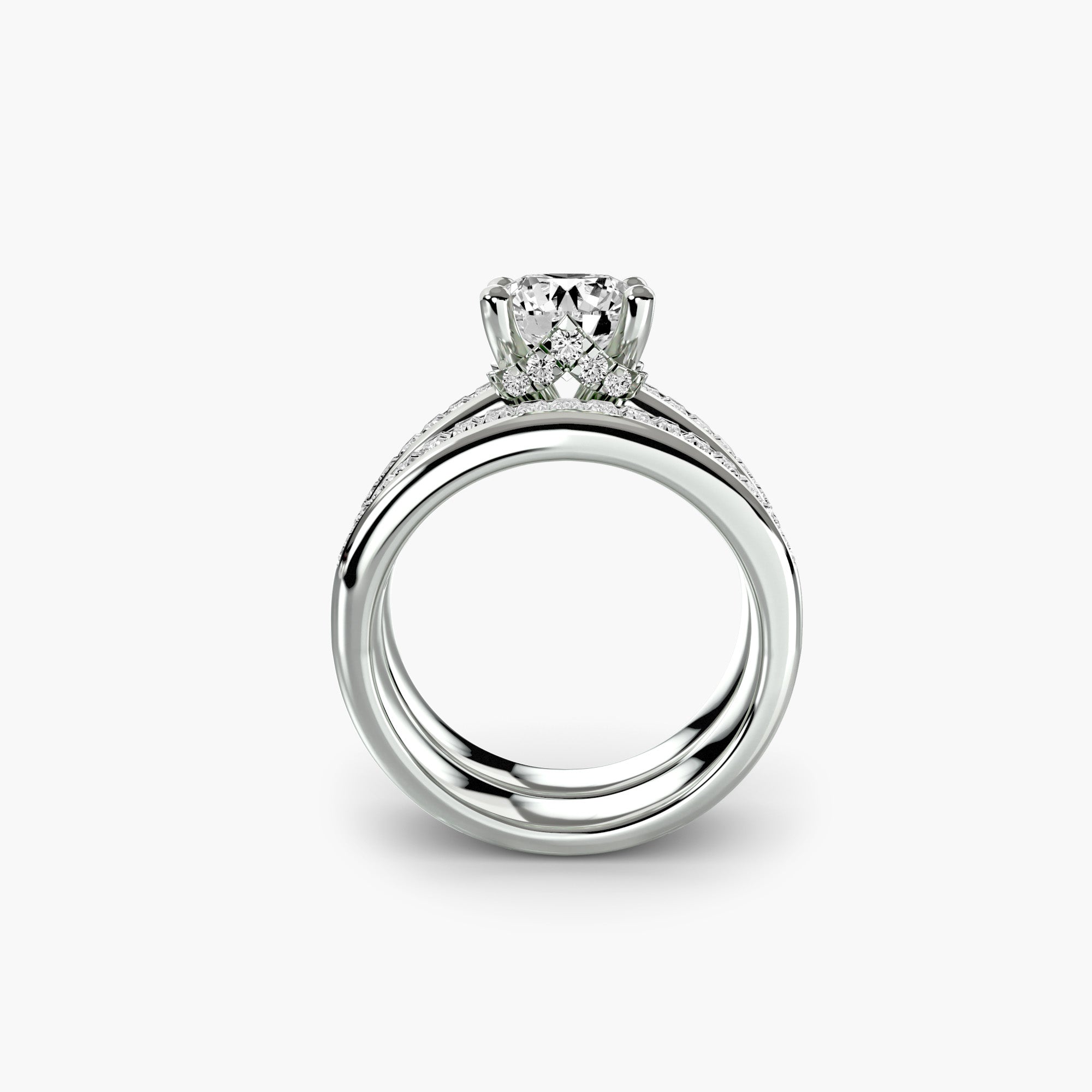 The MICHAEL ISAAC Baguette Channel Solitaire engagement ring showcases a large round-cut diamond solitaire with a band of sparkling baguette diamonds, elegantly displayed on a clean white background.