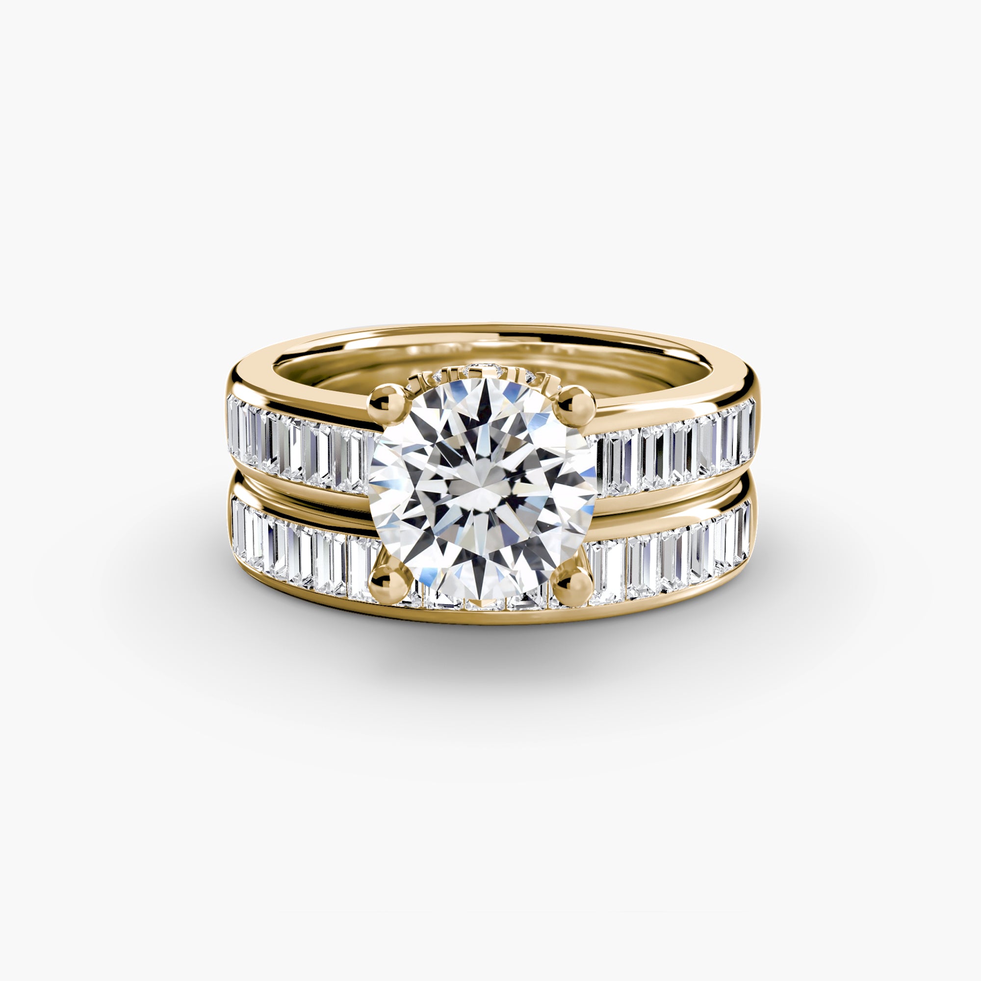 The MICHAEL ISAAC Baguette Channel Solitaire ring set features a large round center diamond with matching bands, both accented by vertical baguette-cut diamonds, shown sparkling on a white background.