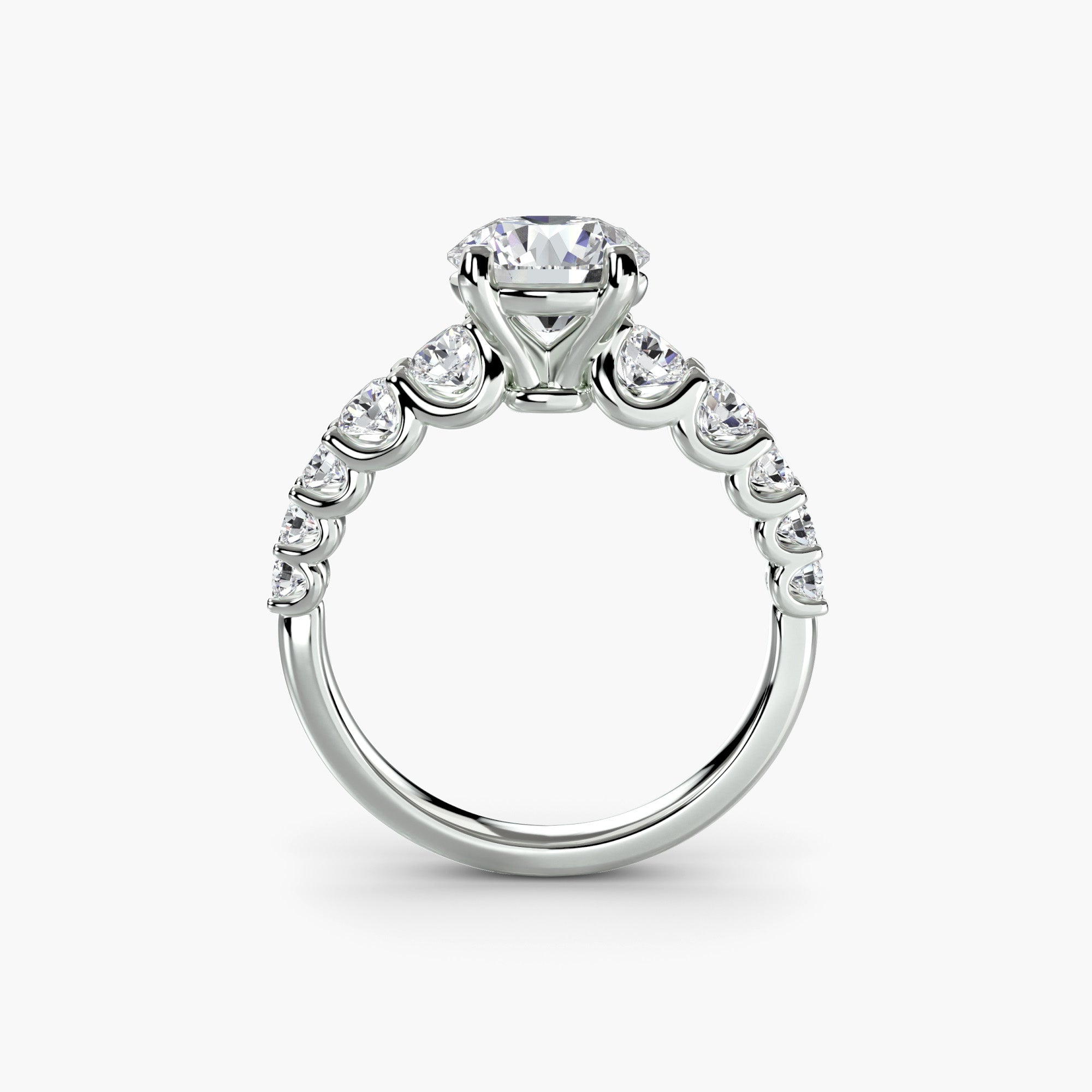 The MICHAEL ISAAC Graduated Accent Ring is a white gold side stone ring with a large round diamond center and accent diamonds along the band, shown from the side against a white background.